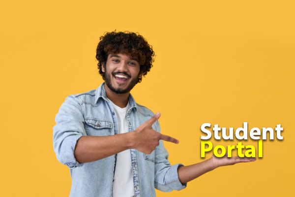 A happy student standing and pointing towards the words 'Student Portal'