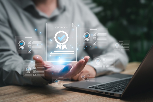 A graphic of a certificate in a male’s hand