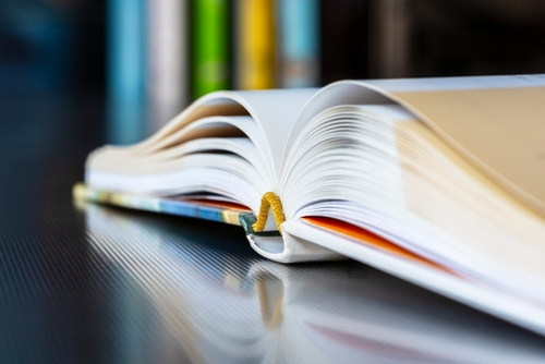 Opened book sitting in a library